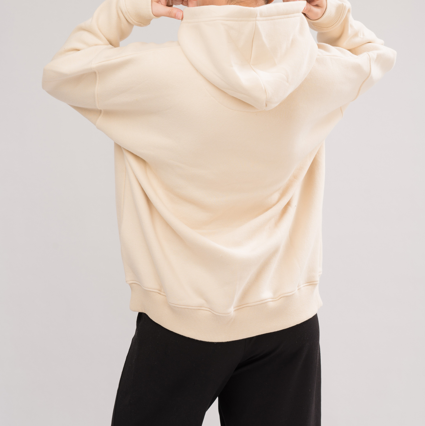 Back view of Women’s Classic Oversized Hoodie in MoonBeam. Designed with a double-layered hood and dropped shoulders for a chic look.