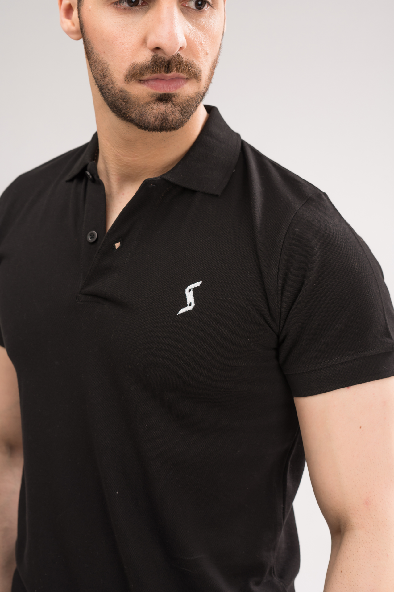 Close-up of Black Classic Polo material, highlighting soft and breathable fabric for ultimate comfort.