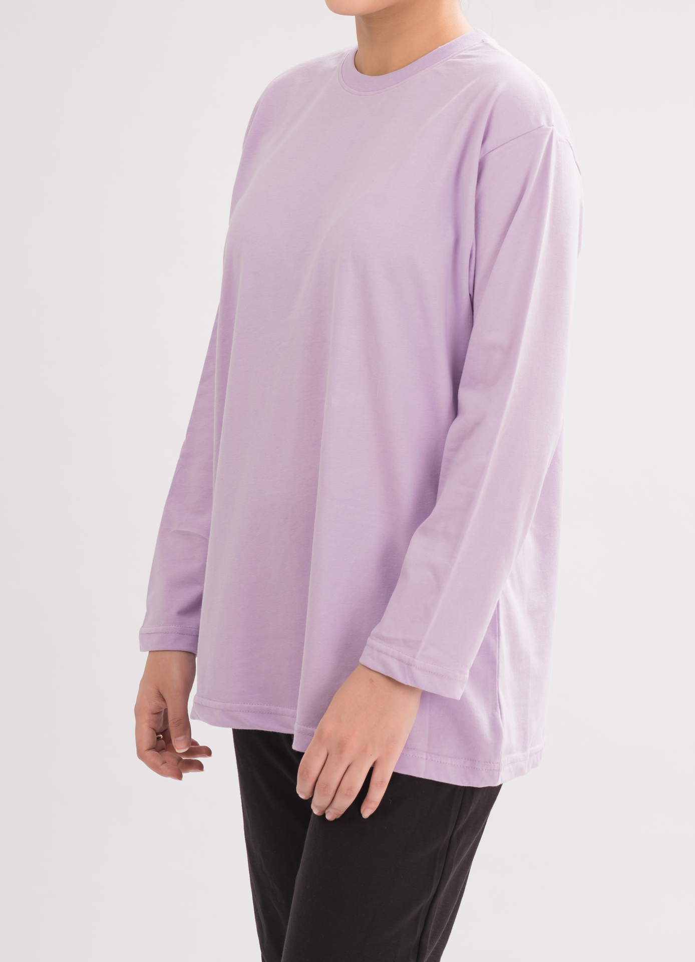 Side view of Women’s Oversized Crew Neck T-Shirt Dress in Lilac. Perfect for everyday wear with a relaxed fit and long sleeves.