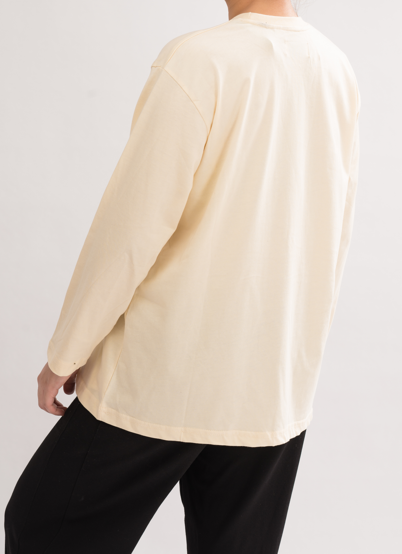 Back view of Women’s Oversized Crew Neck T-Shirt Dress in Cream White. Comfortable and stylish with a crew neck and long sleeves.