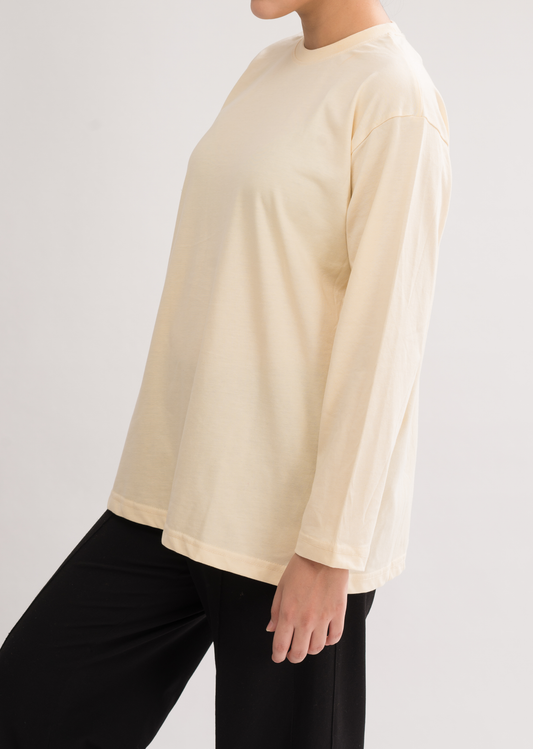 Side view of Women’s Oversized Crew Neck T-Shirt Dress in Cream White. Effortlessly chic with a crew neck and relaxed fit.