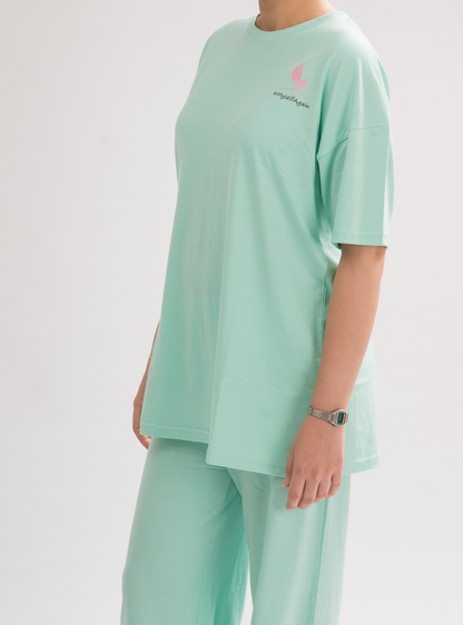 Side view of Women’s HoneyDew Oversized Crew Neck T-Shirt Dress, showcasing the laid-back yet stylish design.