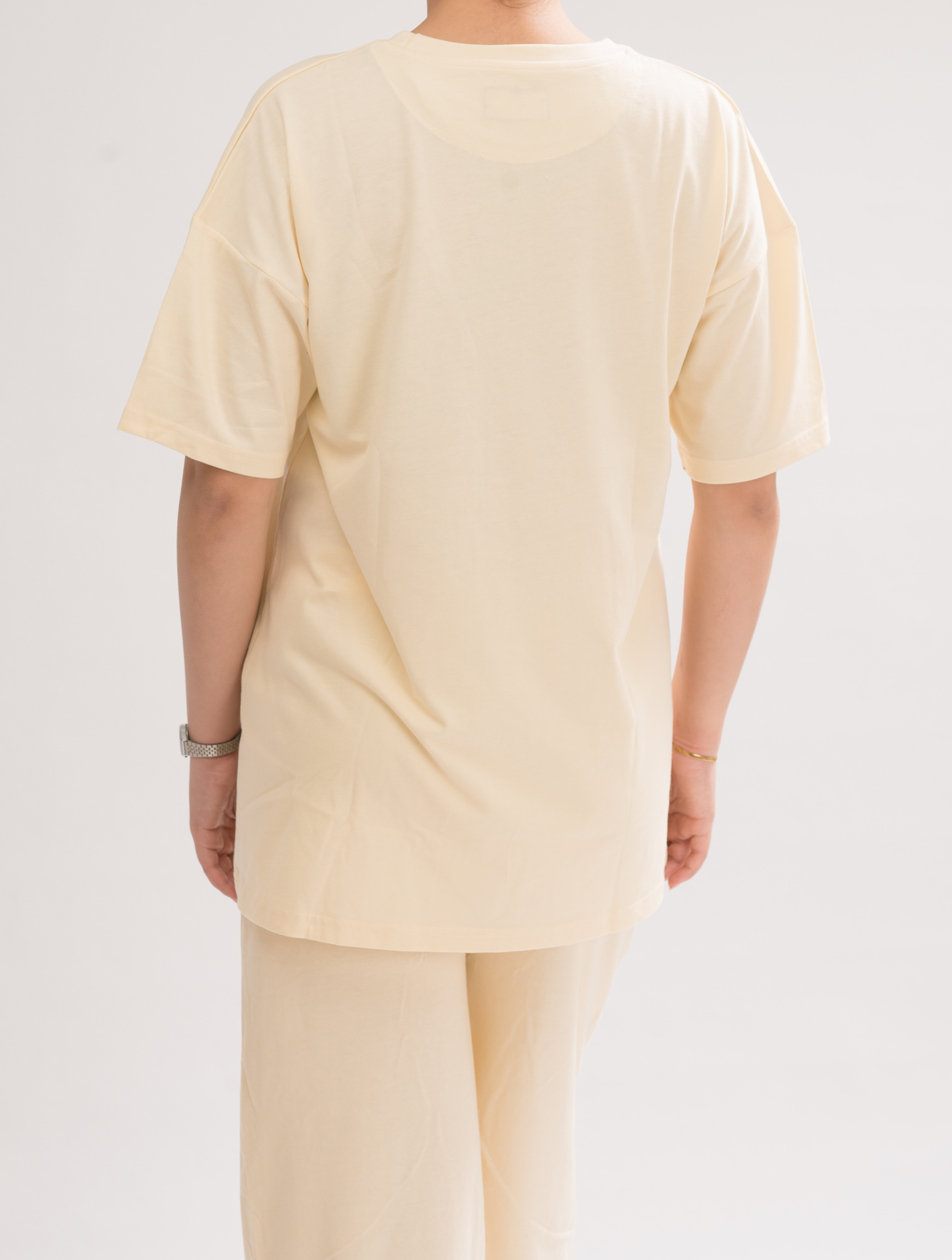 Back view of Women’s Cream White Oversized Crew Neck T-Shirt Dress, displaying the relaxed fit and effortless style.