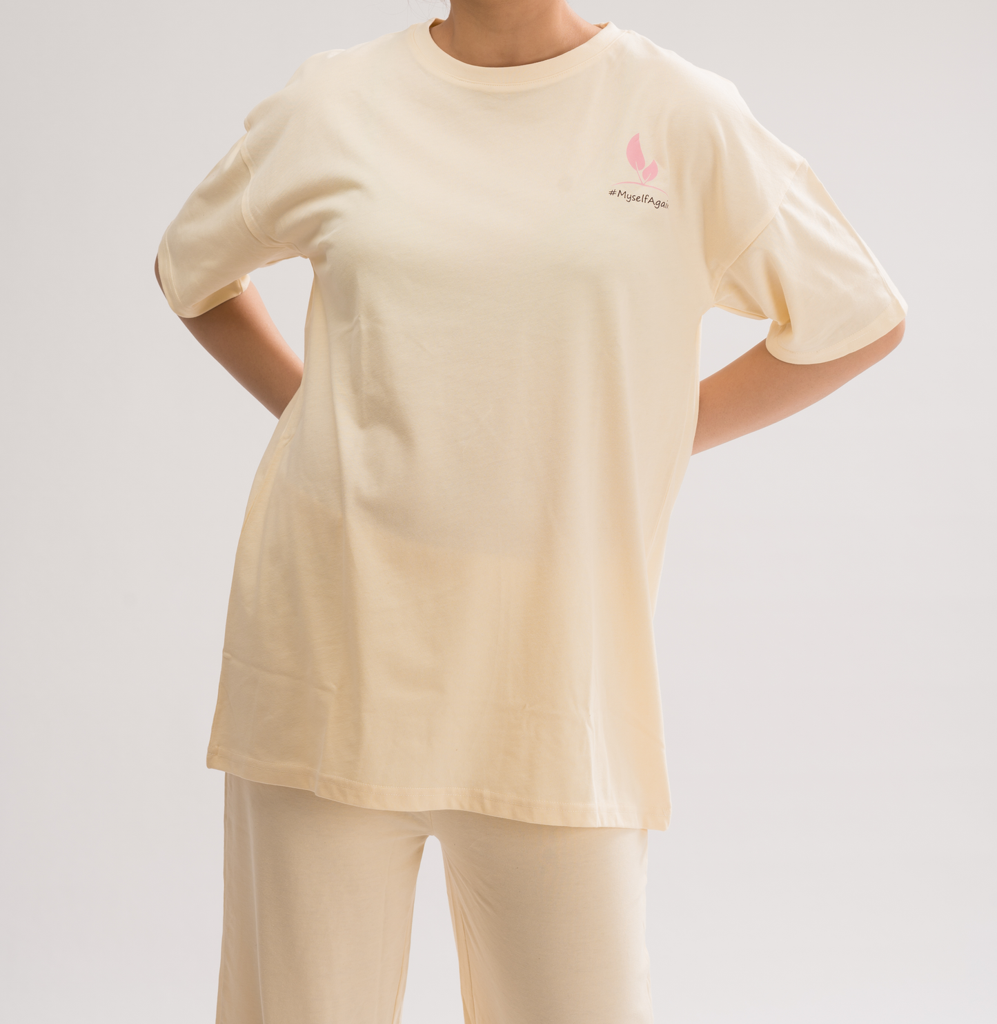 Women’s Cream White Oversized Crew Neck T-Shirt Dress front view, featuring a relaxed fit and half sleeves for a chic and comfortable look.