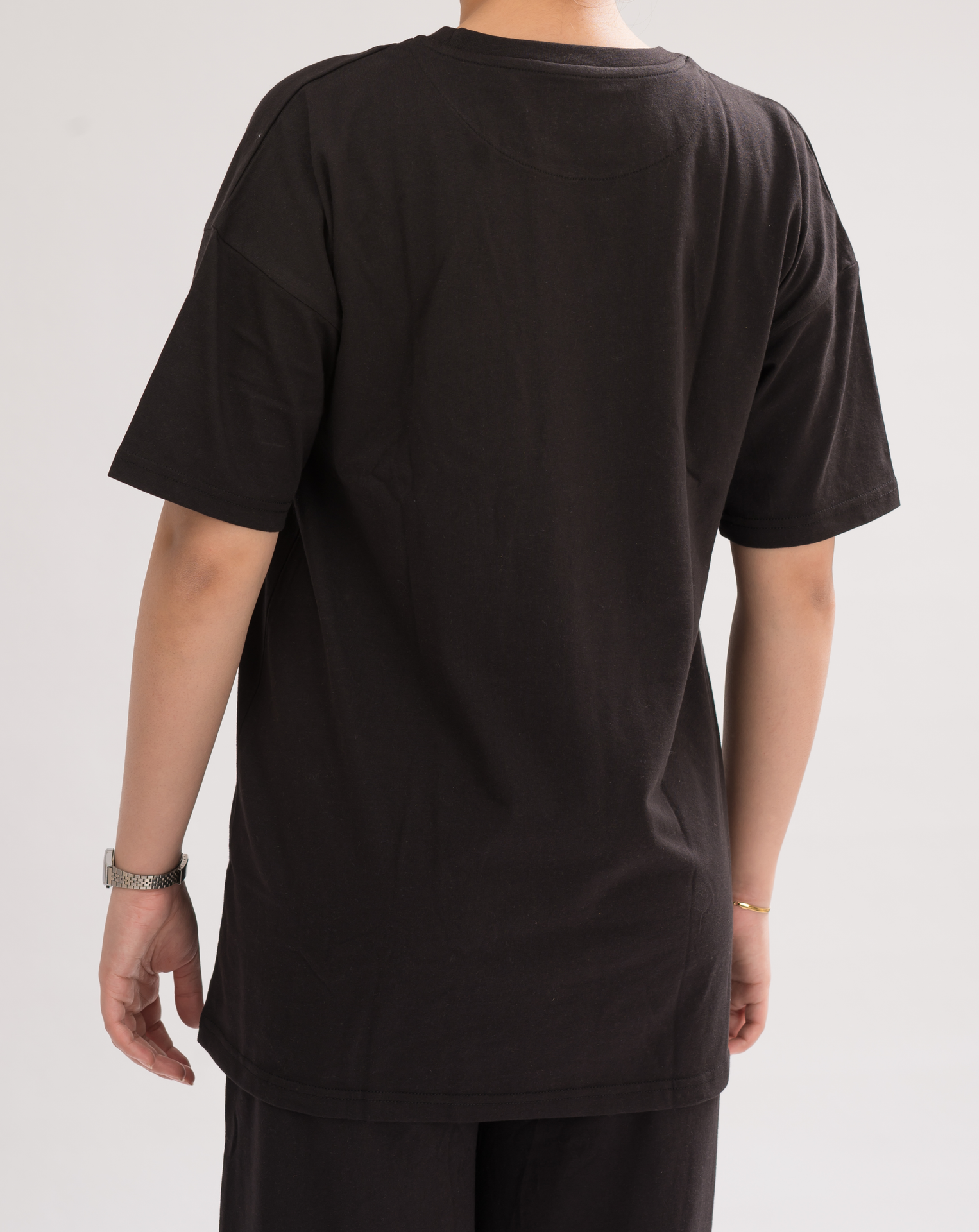 Back view of Women’s Black Oversized Crew Neck T-Shirt Dress, displaying the relaxed fit and effortless style.