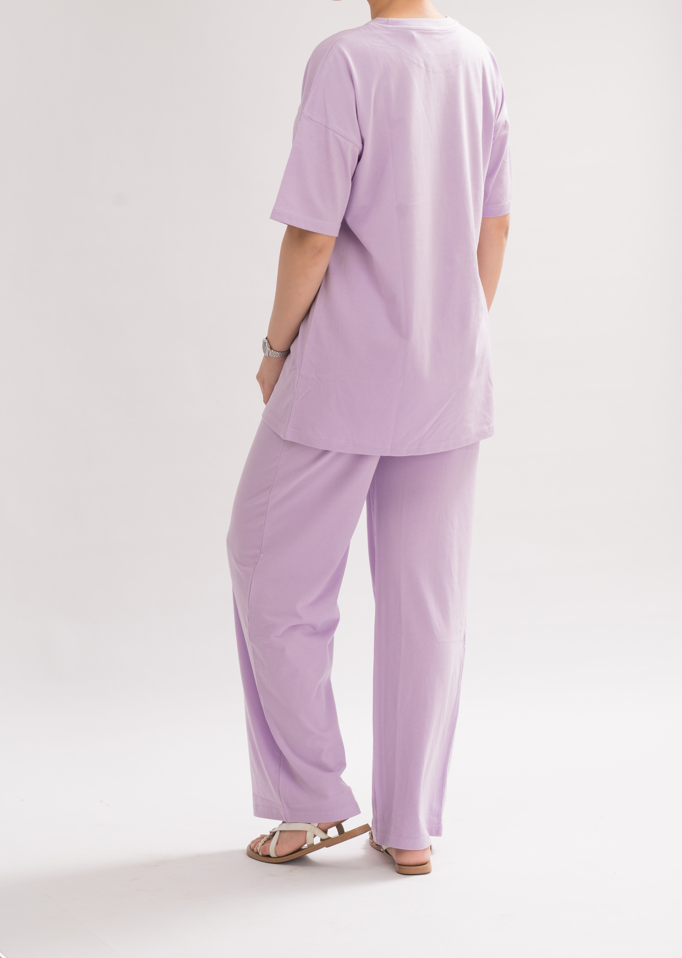 Back view of Women’s Oversized Crew Neck T-Shirt Dress in Lilac. Crew neck design with a relaxed fit for casual chic style.