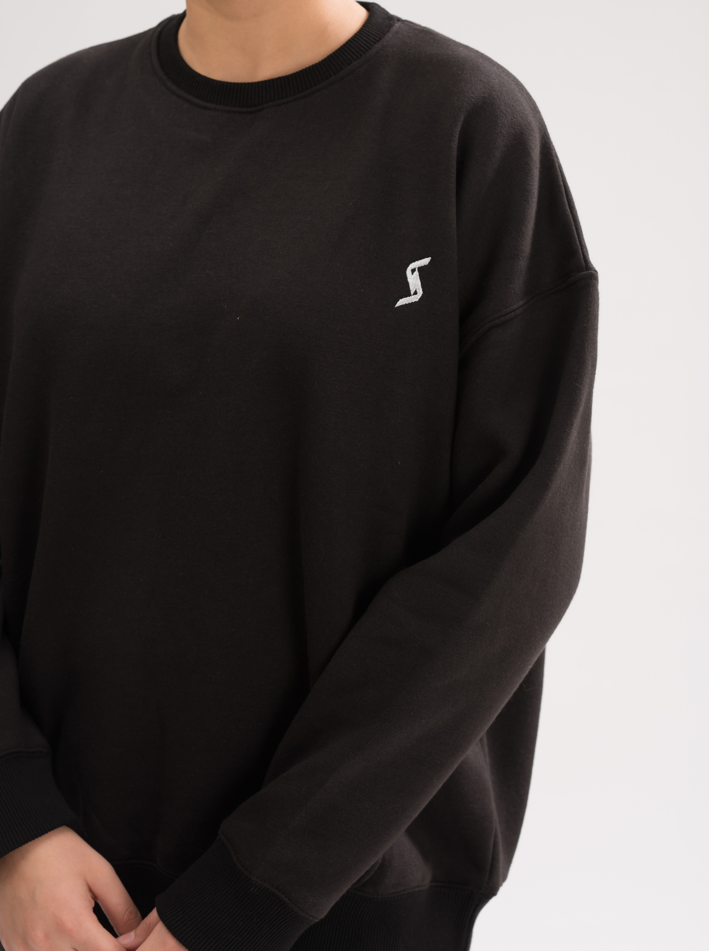 Close-up of the soft brushed interior of Women’s Black Comfortable Loose Fit Sweatshirt, highlighting the premium cotton blend.