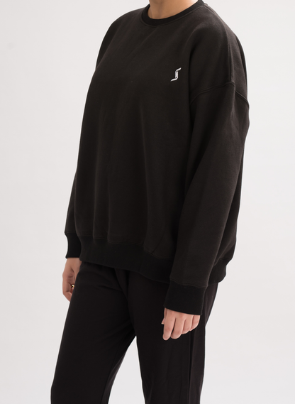 Side view of Women’s Black Comfortable Loose Fit Sweatshirt, showcasing the relaxed fit and modern design.