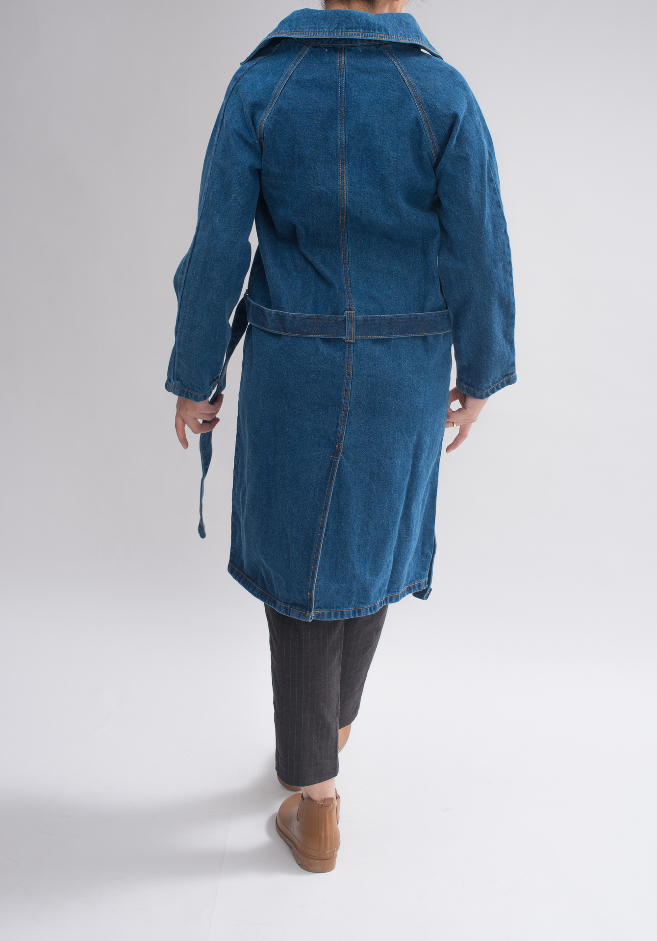 Back view of Women’s Classic Denim Trench Coat, displaying the iconic trench design with double-breasted buttoning and raglan sleeves.