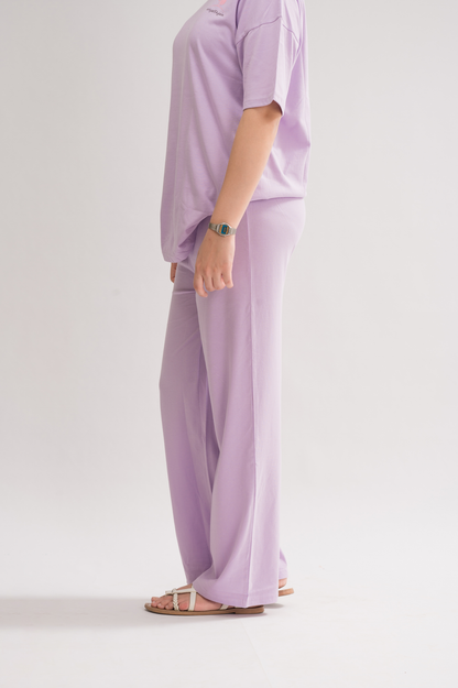 Women’s Lilac Relaxed Fit Flared Cotton Blend Trousers front view, featuring an elasticated waist and stylish flared design.